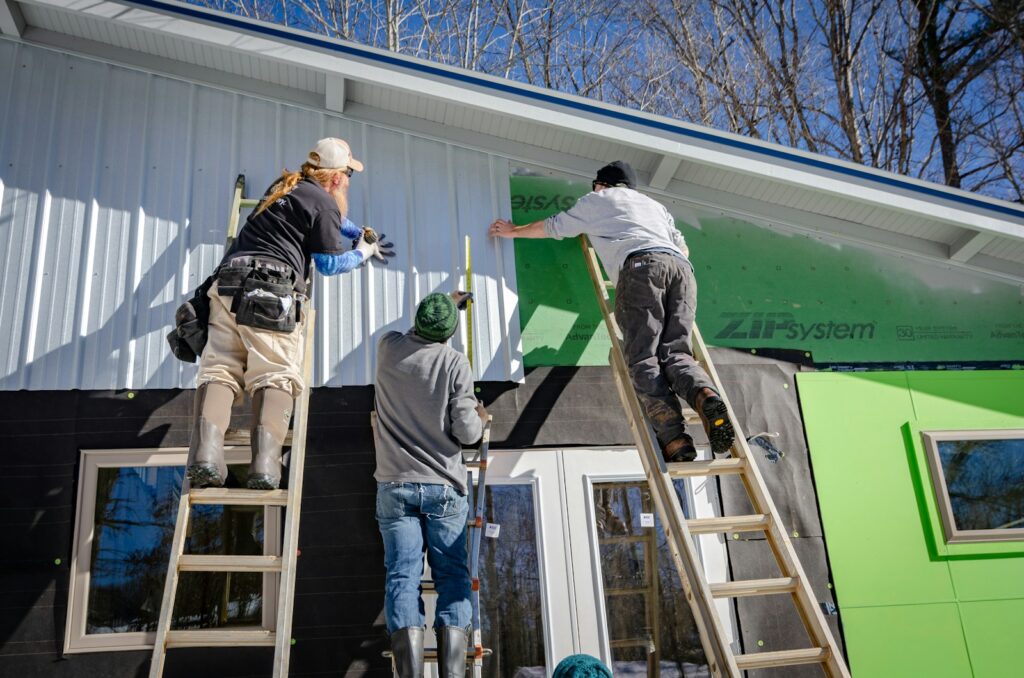 three person climbing on ladder